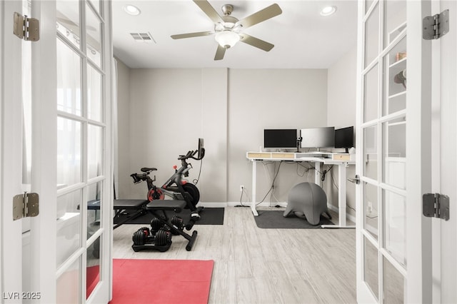 exercise area with light hardwood / wood-style flooring, ceiling fan, and french doors