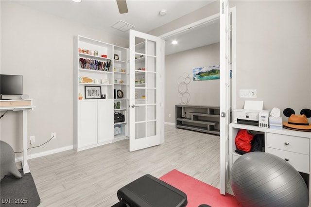 workout room featuring french doors, ceiling fan, and light wood-type flooring