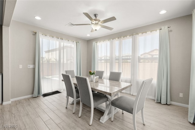 dining area with ceiling fan and light wood-type flooring