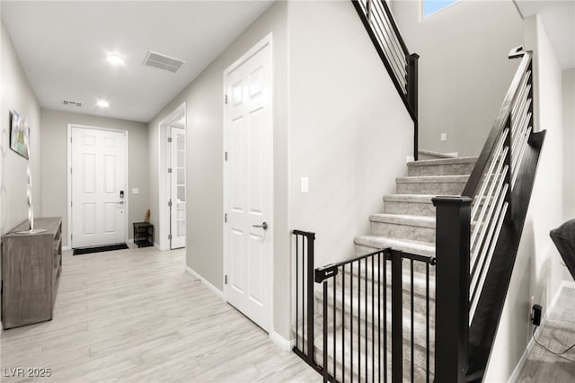 staircase with hardwood / wood-style flooring