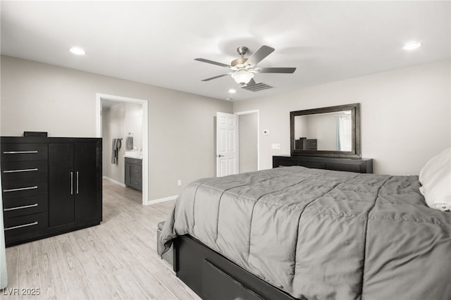 bedroom with ensuite bath, ceiling fan, and light hardwood / wood-style flooring