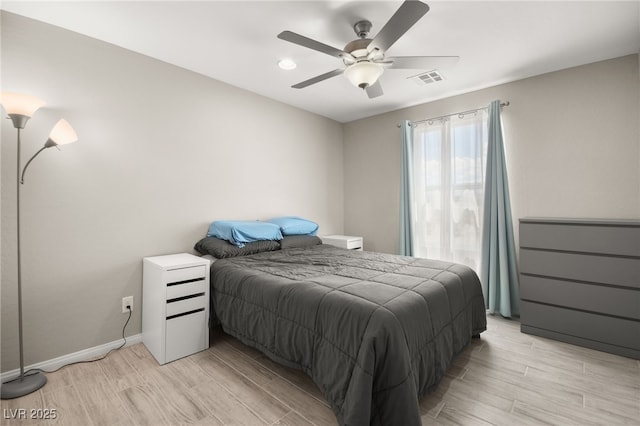 bedroom with ceiling fan and light hardwood / wood-style flooring