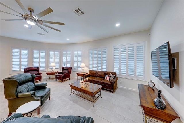 tiled living room with ceiling fan