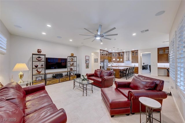 living room featuring ceiling fan and light tile patterned flooring