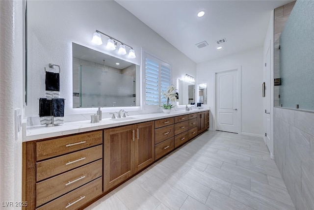 bathroom with vanity and a shower with shower door