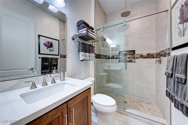 bathroom featuring vanity, toilet, and walk in shower