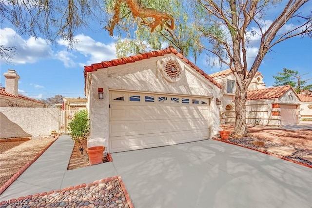 view of front facade featuring a tiled roof, an outdoor structure, concrete driveway, and stucco siding