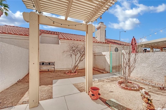 view of patio / terrace with a fenced backyard, a gate, and a pergola