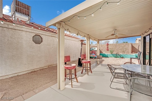 view of patio / terrace with outdoor dining space, a fenced backyard, and ceiling fan