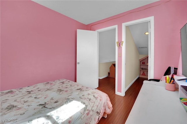 bedroom with baseboards and dark wood-style flooring