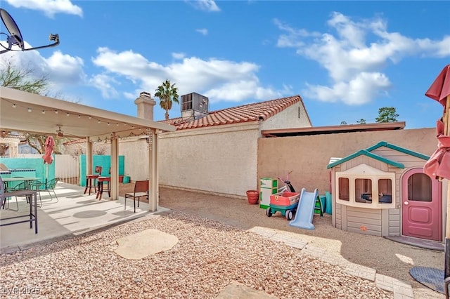 exterior space featuring cooling unit and fence