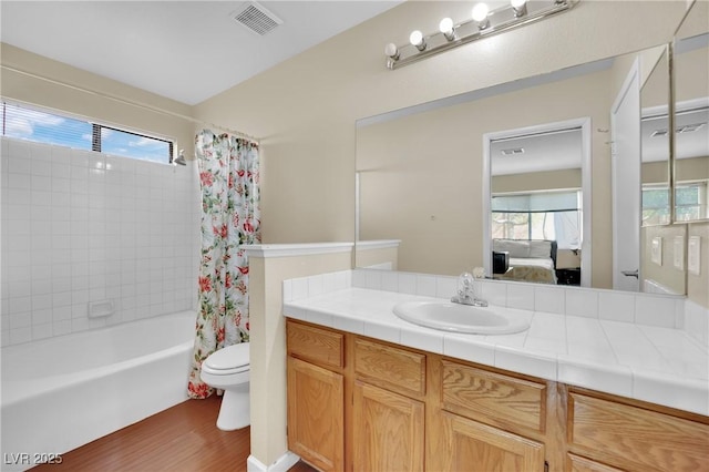 full bathroom with toilet, shower / tub combo, vanity, visible vents, and ensuite bath