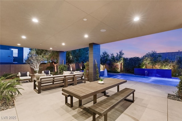 patio terrace at dusk with a fenced in pool and outdoor lounge area