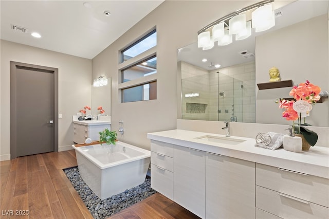 bathroom with vanity, wood-type flooring, and separate shower and tub