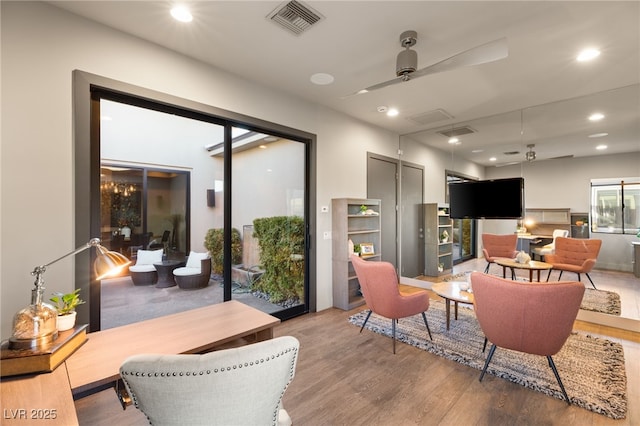 living room featuring hardwood / wood-style flooring and ceiling fan