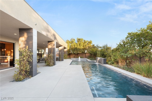 view of pool featuring pool water feature and a patio area