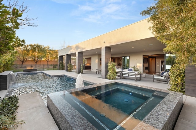 view of swimming pool with a patio, outdoor lounge area, pool water feature, and an in ground hot tub