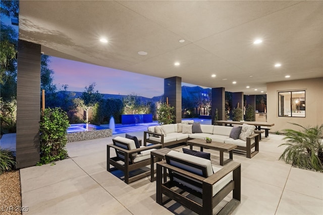 patio terrace at dusk featuring an outdoor living space