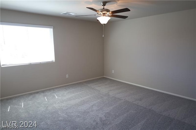 carpeted spare room featuring ceiling fan