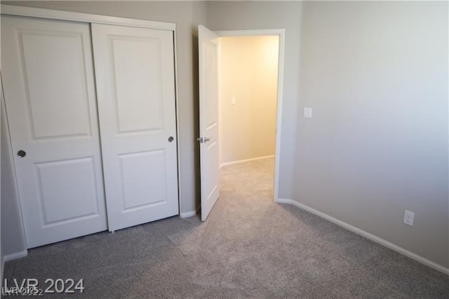 unfurnished bedroom featuring carpet floors and a closet