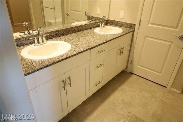 bathroom featuring tile patterned flooring and vanity