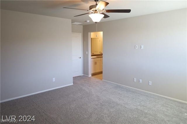 empty room featuring light carpet and ceiling fan