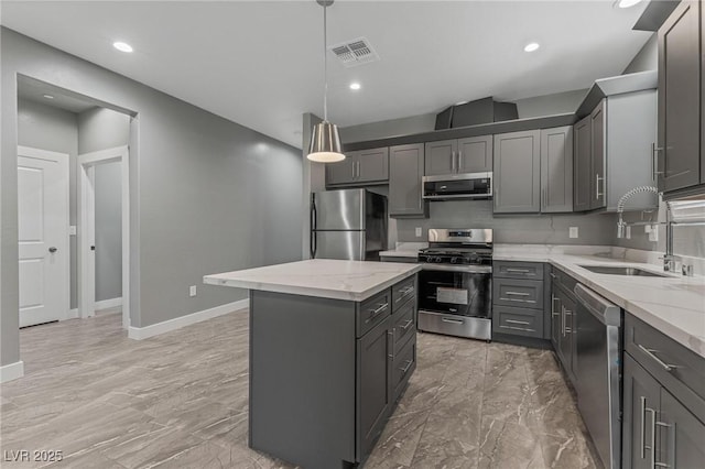 kitchen with sink, gray cabinetry, decorative light fixtures, a center island, and stainless steel appliances