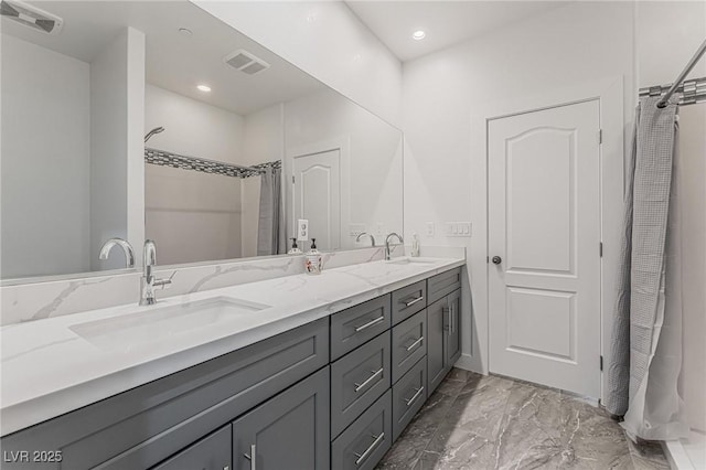 bathroom with walk in shower and vanity