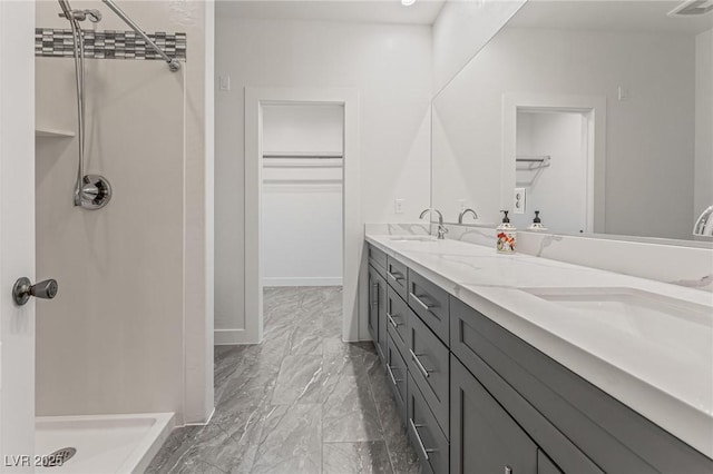 bathroom with vanity and a shower