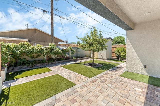 view of yard with a patio area and a storage unit