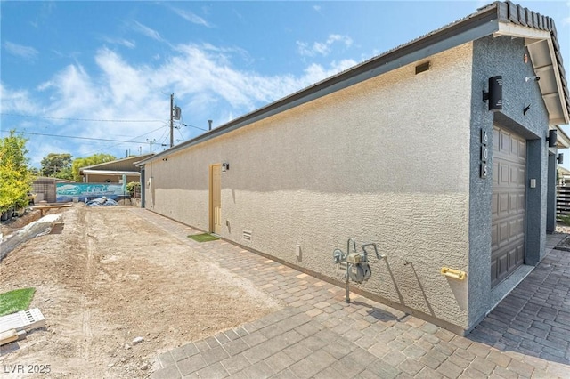 view of side of home with a garage