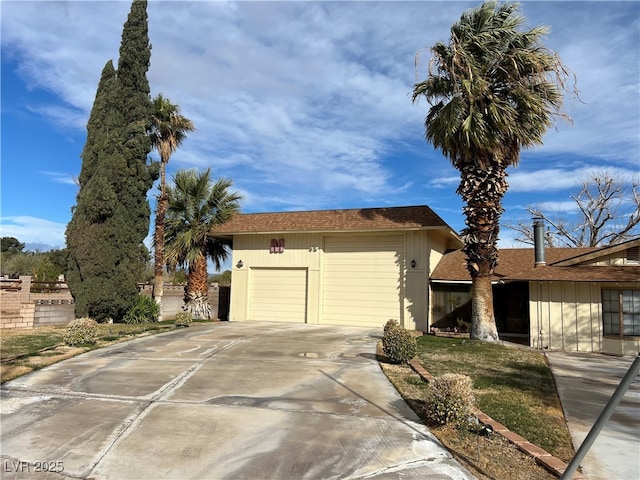 view of side of home featuring a garage and driveway