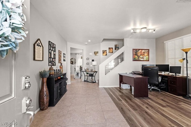 home office featuring light tile patterned floors, visible vents, and baseboards