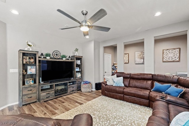 living area with wood finished floors, a ceiling fan, and recessed lighting