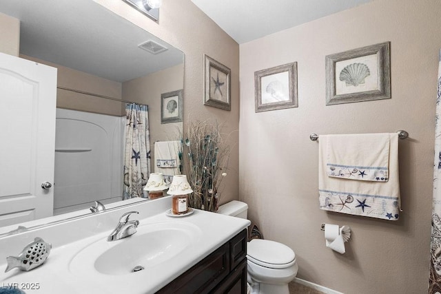 bathroom featuring curtained shower, visible vents, vanity, and toilet