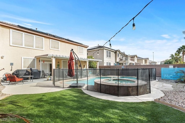 view of pool with an in ground hot tub, a lawn, a patio area, and fence