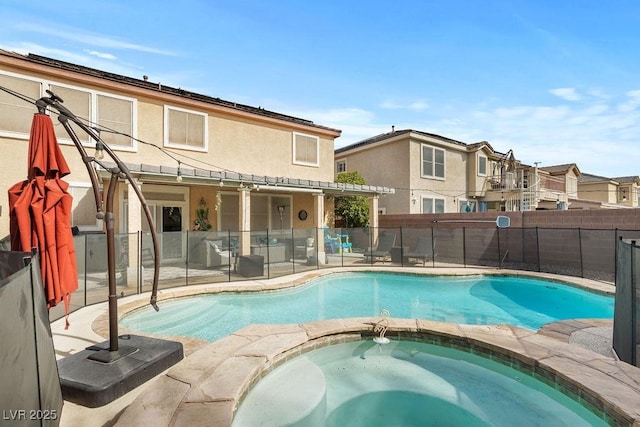 view of swimming pool featuring a patio, fence, a fenced in pool, and an in ground hot tub