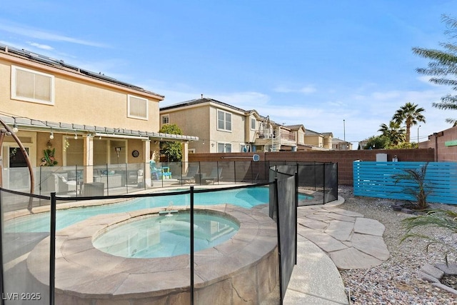 view of pool with an in ground hot tub, a fenced backyard, and a fenced in pool