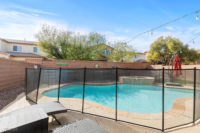 view of swimming pool featuring a fenced backyard and a pool with connected hot tub