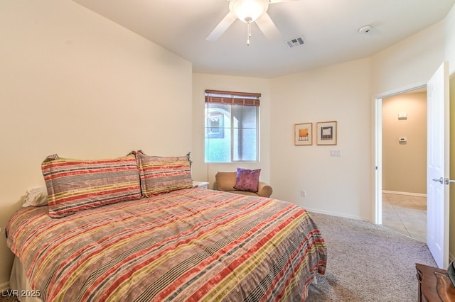 bedroom featuring light colored carpet and ceiling fan