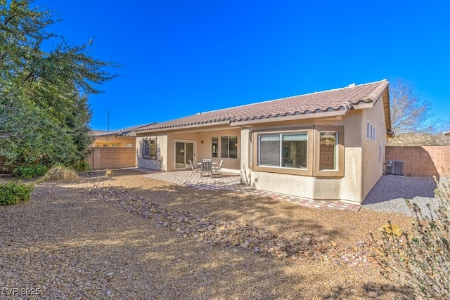 rear view of house with a patio and central air condition unit