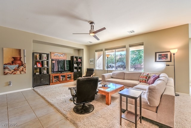 tiled living room with ceiling fan