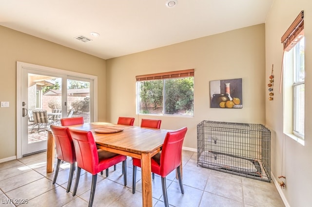 tiled dining room featuring plenty of natural light