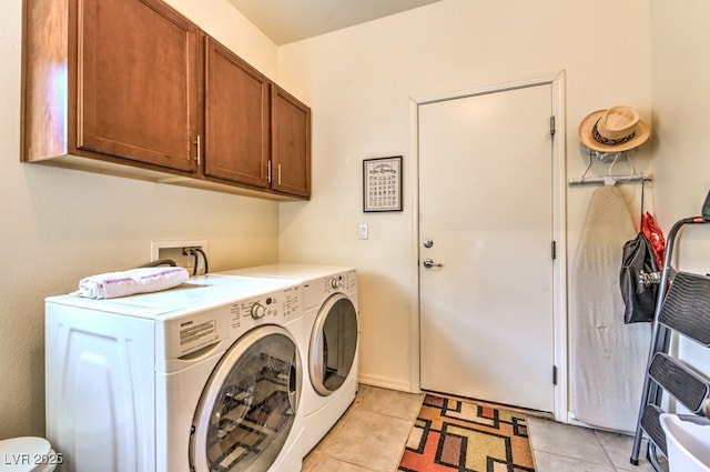 laundry room with cabinets, independent washer and dryer, and light tile patterned floors