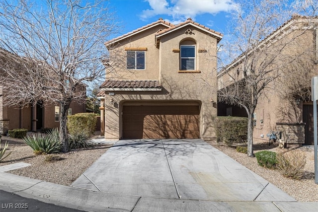 mediterranean / spanish home featuring a garage, driveway, a tiled roof, and stucco siding