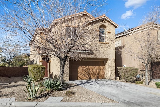 view of front of house featuring a tile roof, stucco siding, concrete driveway, an attached garage, and fence