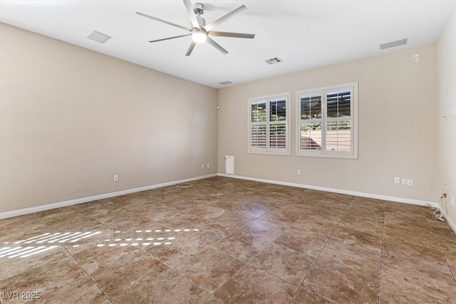 spare room featuring baseboards, visible vents, and a ceiling fan