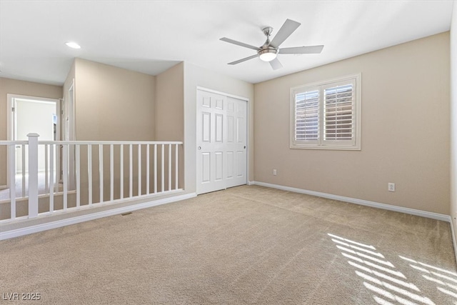 carpeted empty room with ceiling fan, recessed lighting, and baseboards