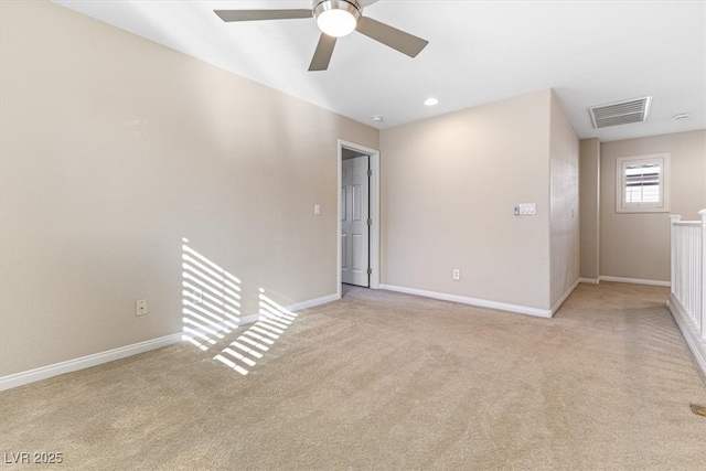 unfurnished room featuring a ceiling fan, carpet, visible vents, and baseboards