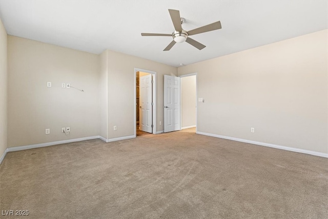 spare room with carpet, baseboards, and ceiling fan